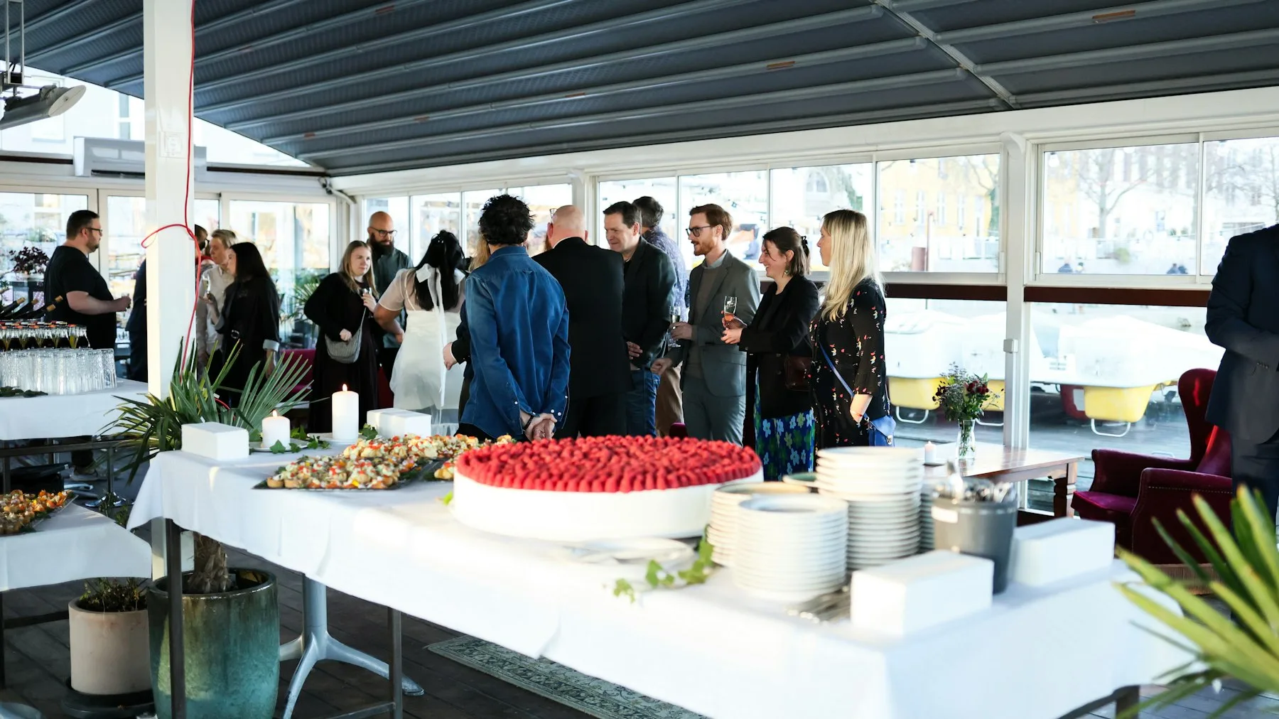 Collègues debout autour d'une table de buffet en fin de journée